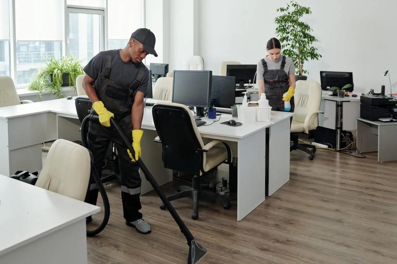 a person and person cleaning an office